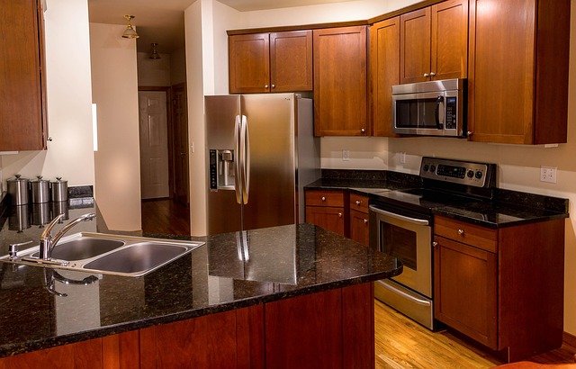 Kitchen Reno Mississauga with brand new cherry cabinets and black granite countertops